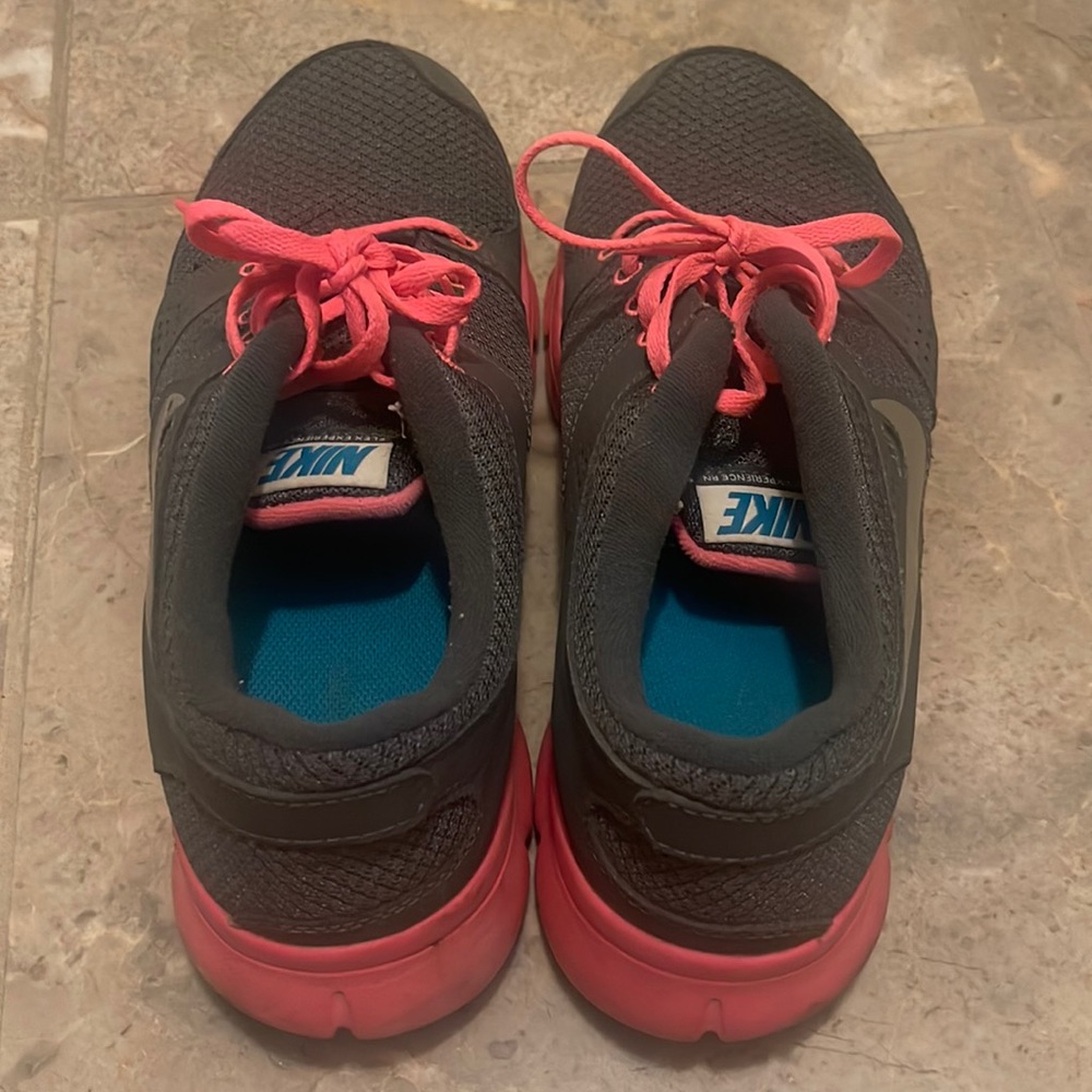 Nike shoe size 9.5. Color gray with hot pink highlights and lace.
